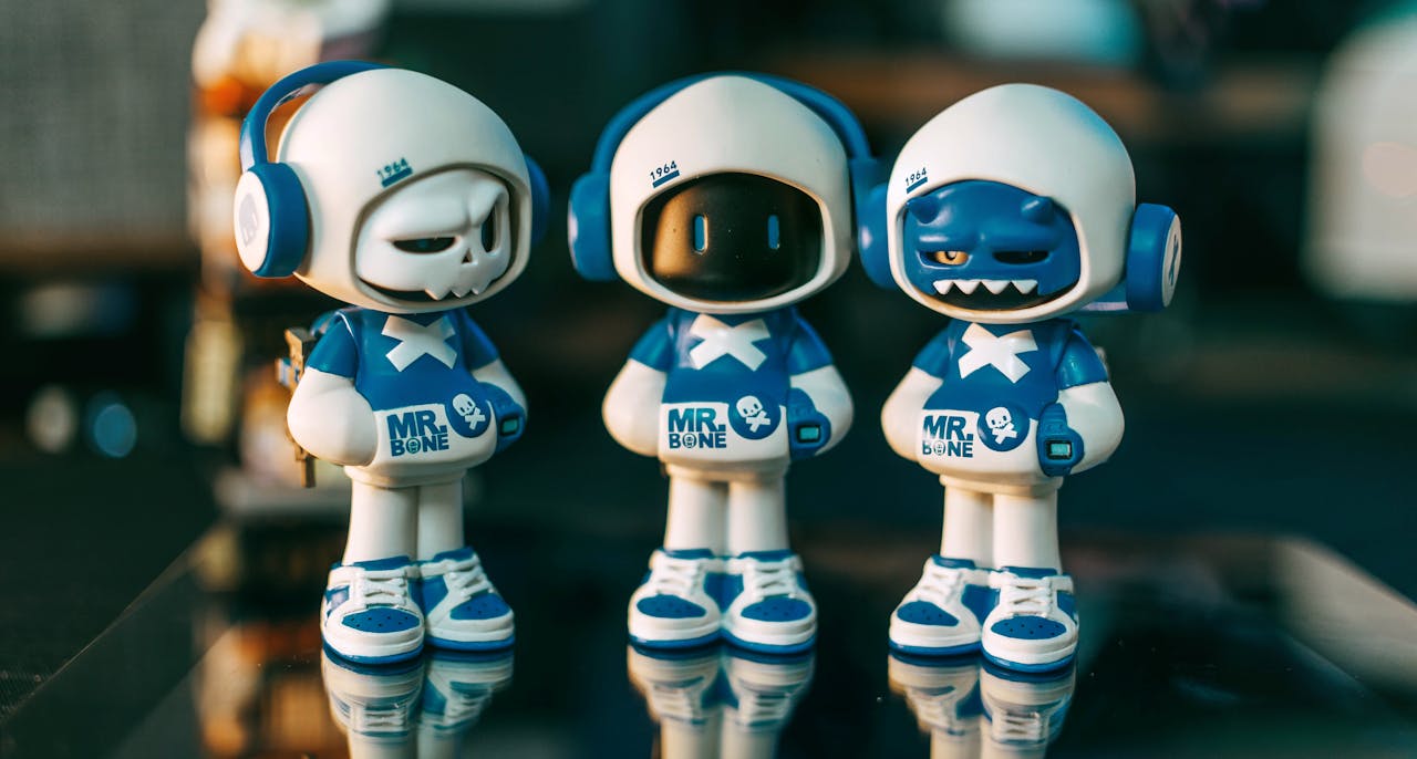 Three toy figures wearing blue and white costumes with headphones, labeled Mr. Bone.