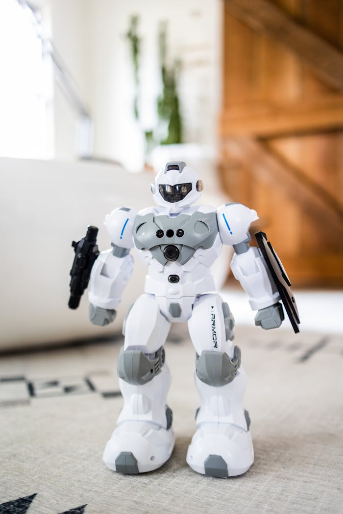Creative design of plastic toy robot with firearms on rug in house room on sunny day